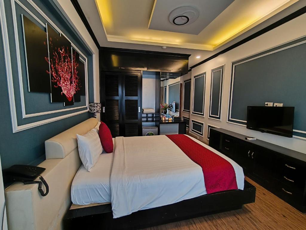 Postel nebo postele na pokoji v ubytování Eclipse Legend Hotel