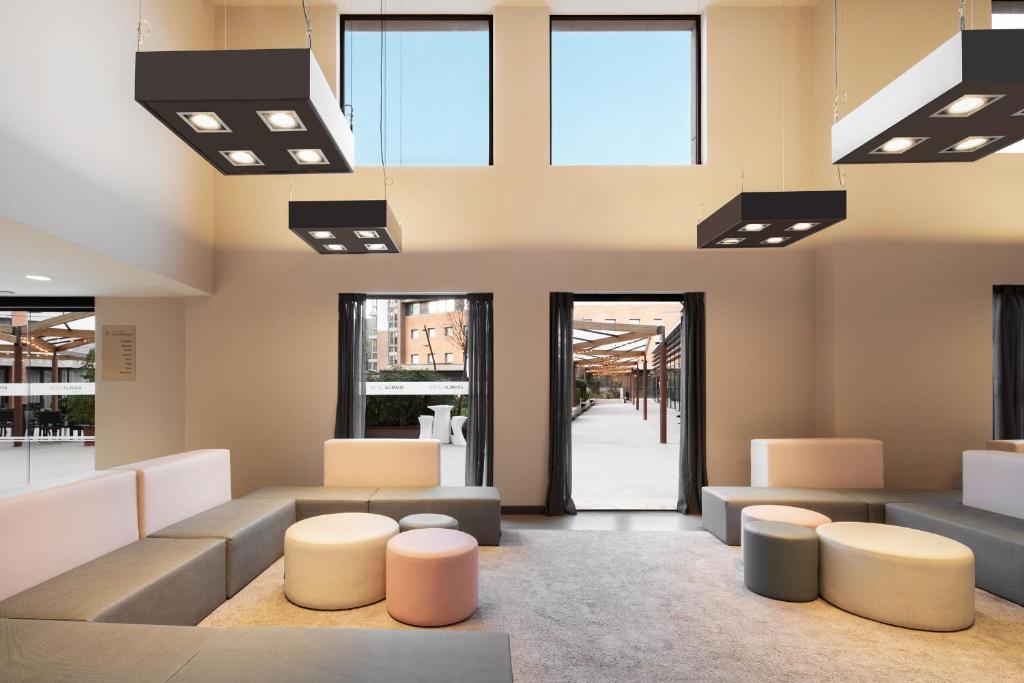 a waiting room with couches and tables and windows at Hotel Alimara in Barcelona