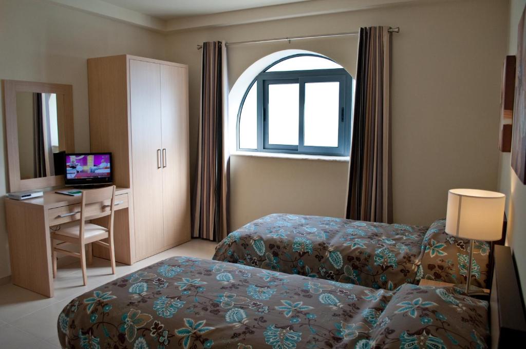 Postel nebo postele na pokoji v ubytování Hotel Kappara