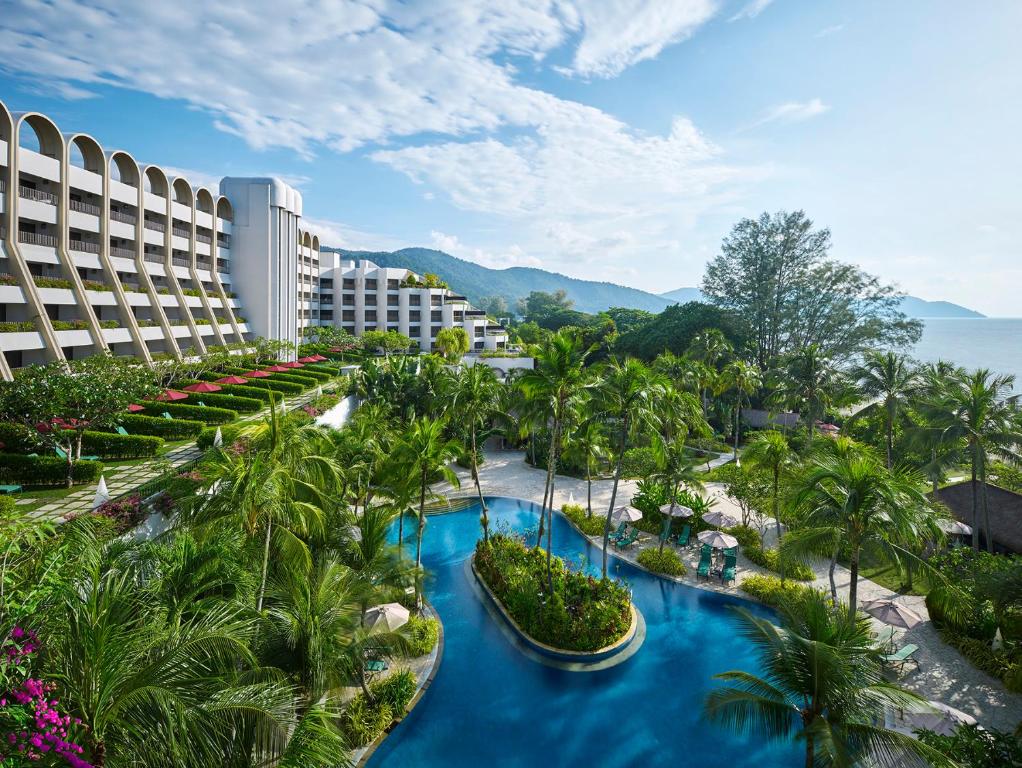 an aerial view of a resort with blue water and palm trees at PARKROYAL Penang Resort in Batu Ferringhi