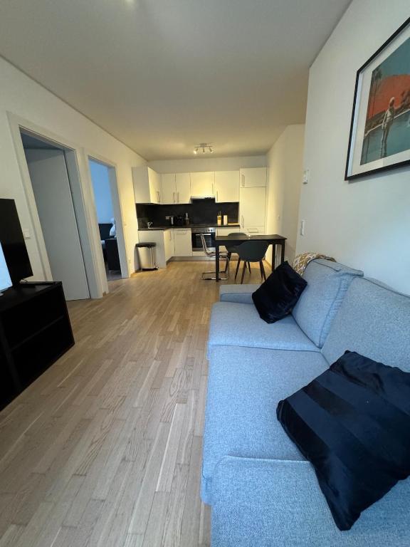 a living room with a blue couch and a table at Studio University in Graz