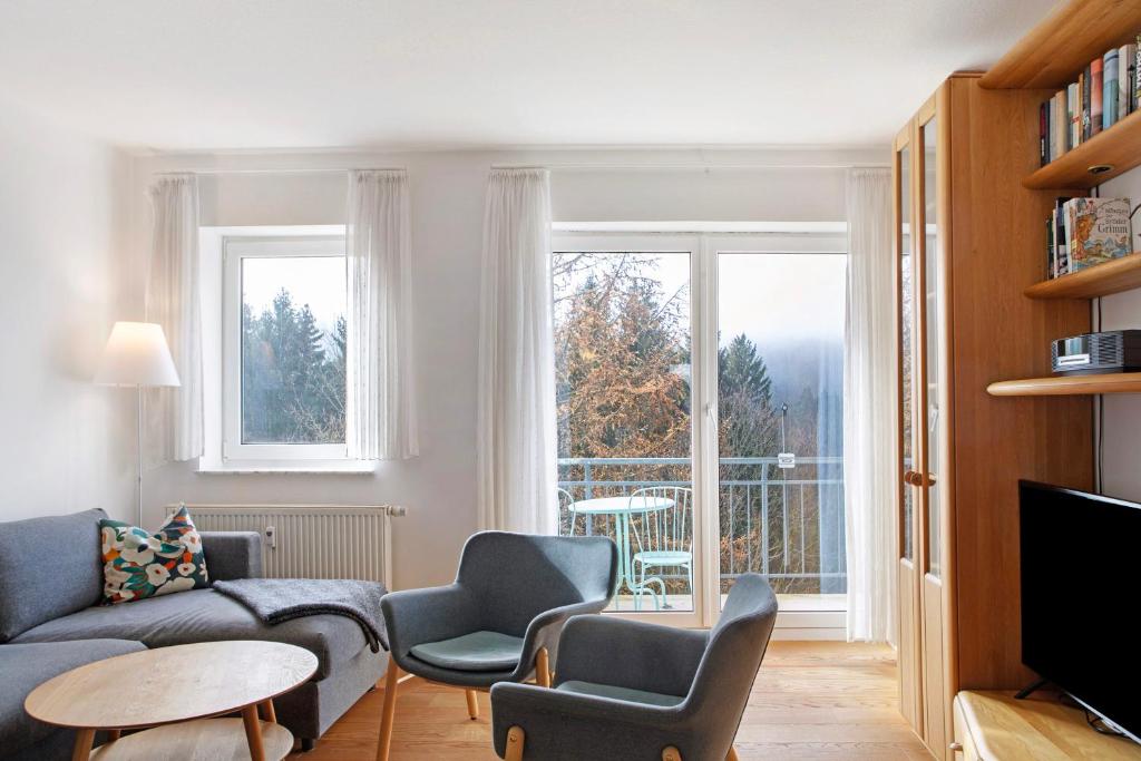 a living room with a couch and chairs and a window at Ferienwohnung Tannenblick 6-2 in Oberhof