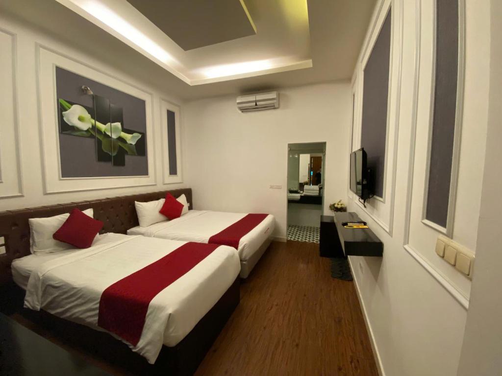 Postel nebo postele na pokoji v ubytování Eclipse Legend Hotel