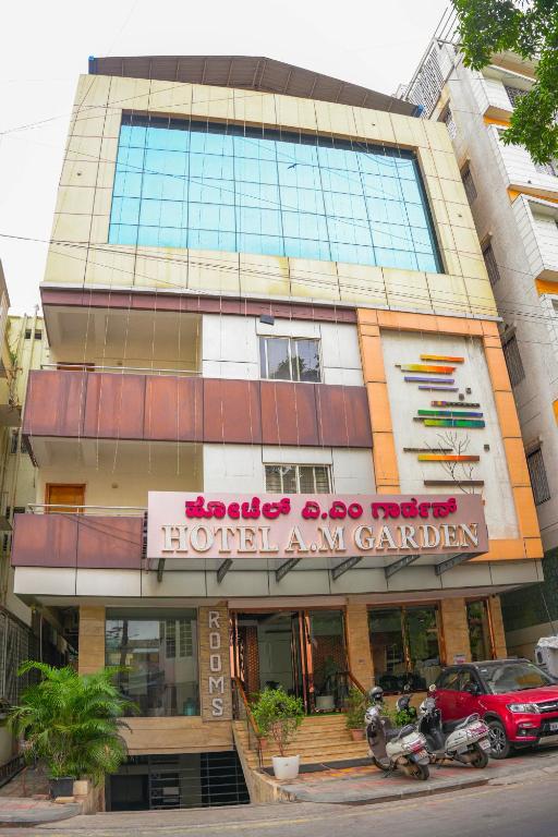a building with a sign on the front of it at Octave Hotel AM Garden in Bangalore