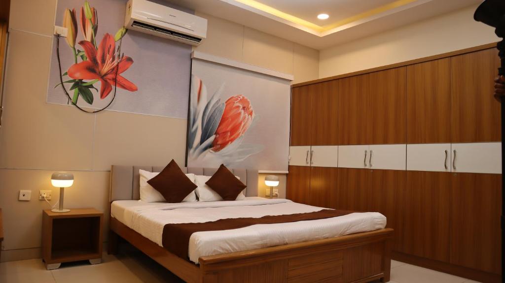 a bedroom with a bed and a painting on the wall at Dcasa Apartment Hotel in Hyderabad