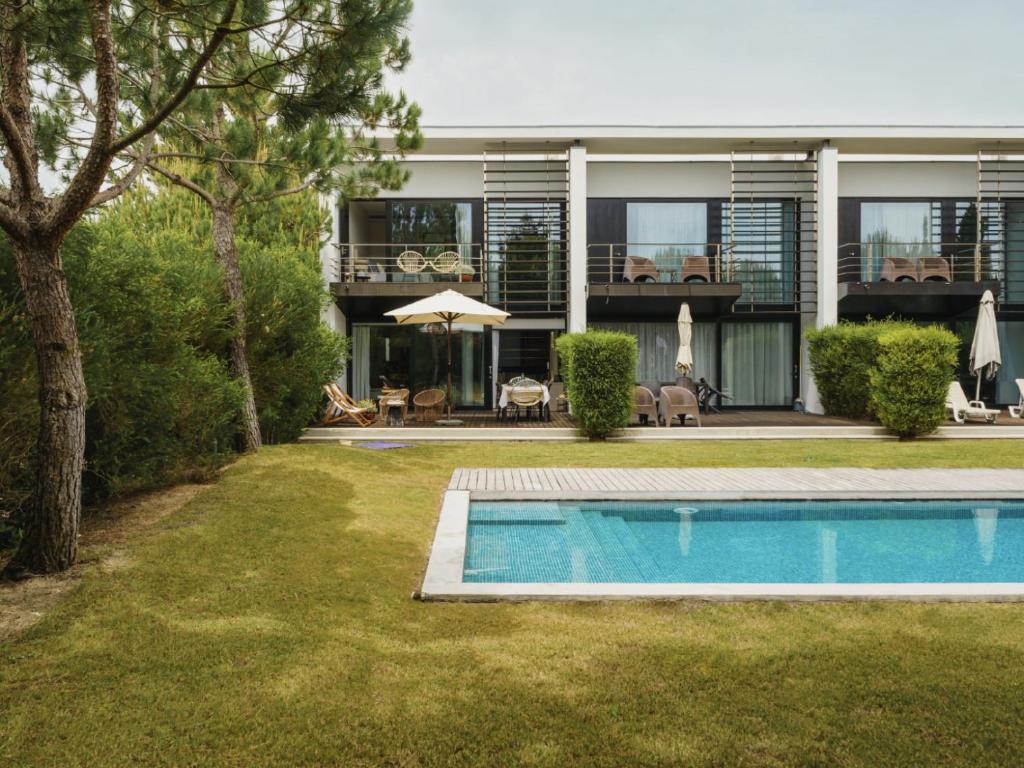 an exterior view of a house with a swimming pool at Pool Beach & Golf Troia Reserve V3 in Troia