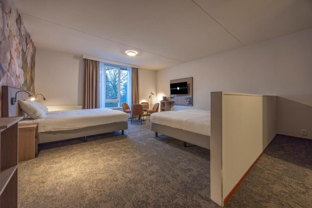 Postel nebo postele na pokoji v ubytování Fletcher Parkhotel Val Monte