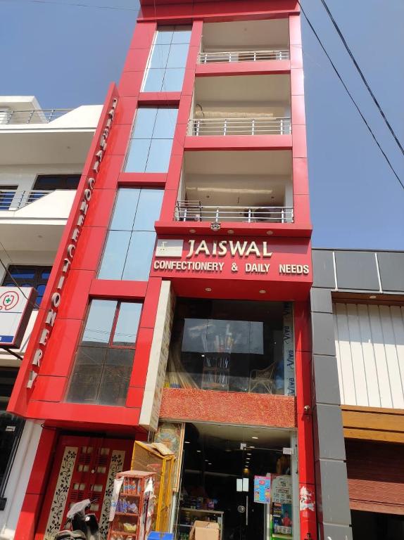 a red building with a sign on the side of it at Jaiswal Home Stay in Rishīkesh