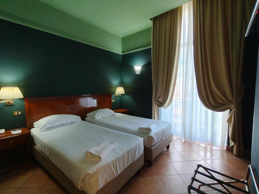 Postel nebo postele na pokoji v ubytování Hotel Nuvò