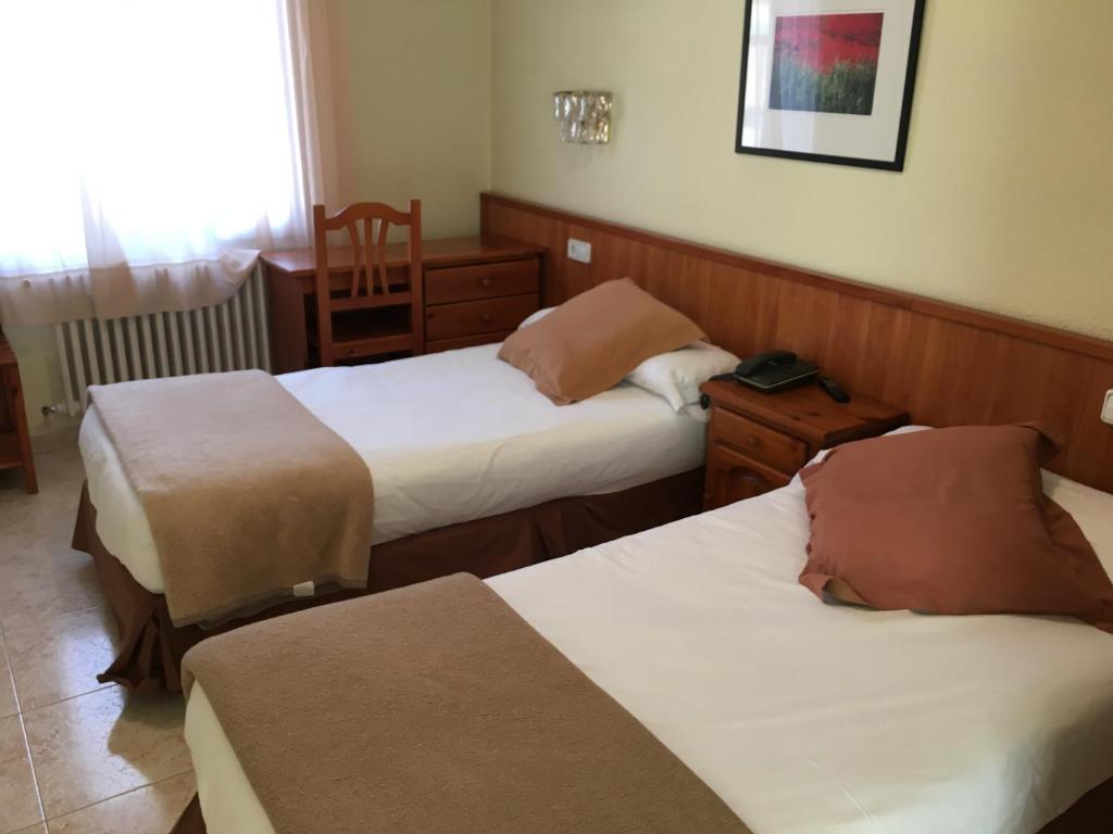Postel nebo postele na pokoji v ubytování Evenia Oros