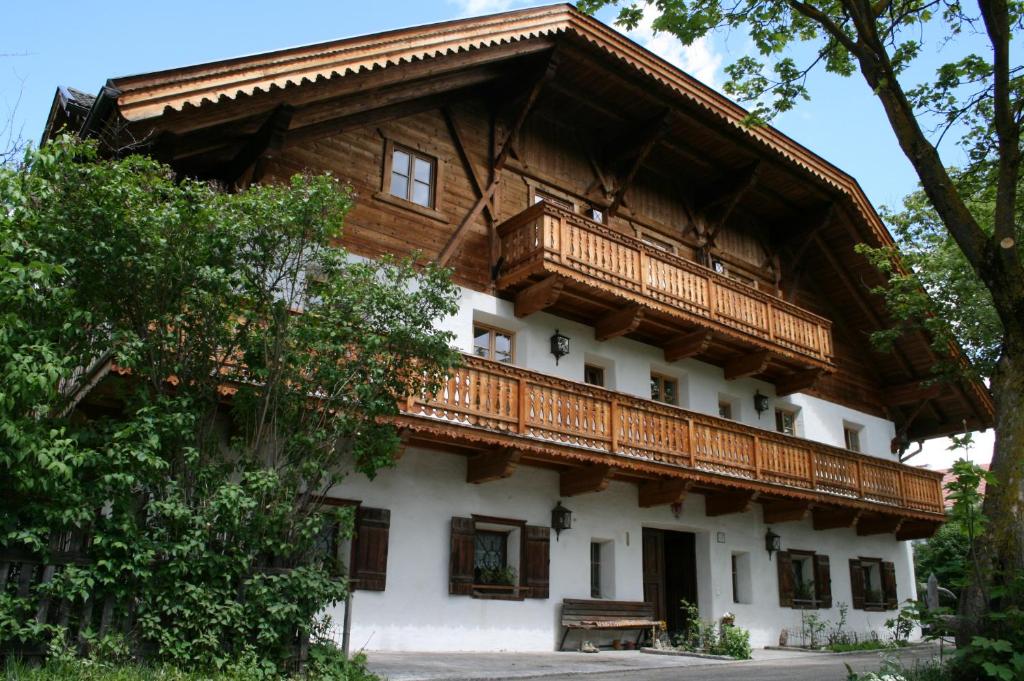 a house with a wooden balcony on top of it at Apperlehof in Villabassa