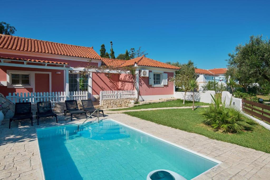 a swimming pool in the backyard of a house at Villa Erato Periyali in Vasilikos