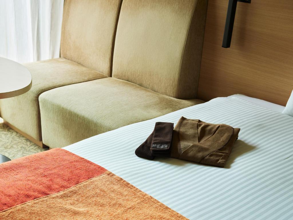 Postel nebo postele na pokoji v ubytování Mitsui Garden Hotel Kashiwa-No-Ha - Chiba