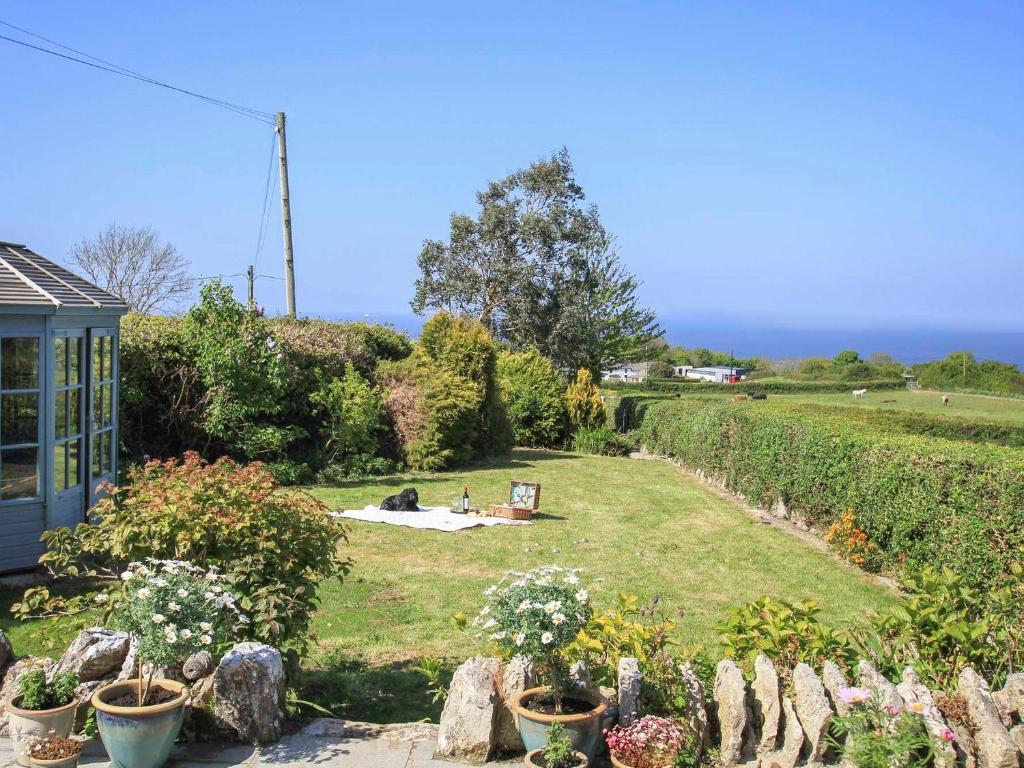 a garden with a view of the ocean at Goleufryn in Beaumaris