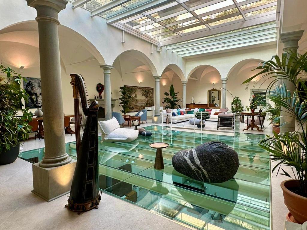 a lobby with a glass floor in a building at Dimora Collection - Le Corti - Boutique Luxury Suites in a Restored 13th Century Convent, with Sauna and Gym in Florence