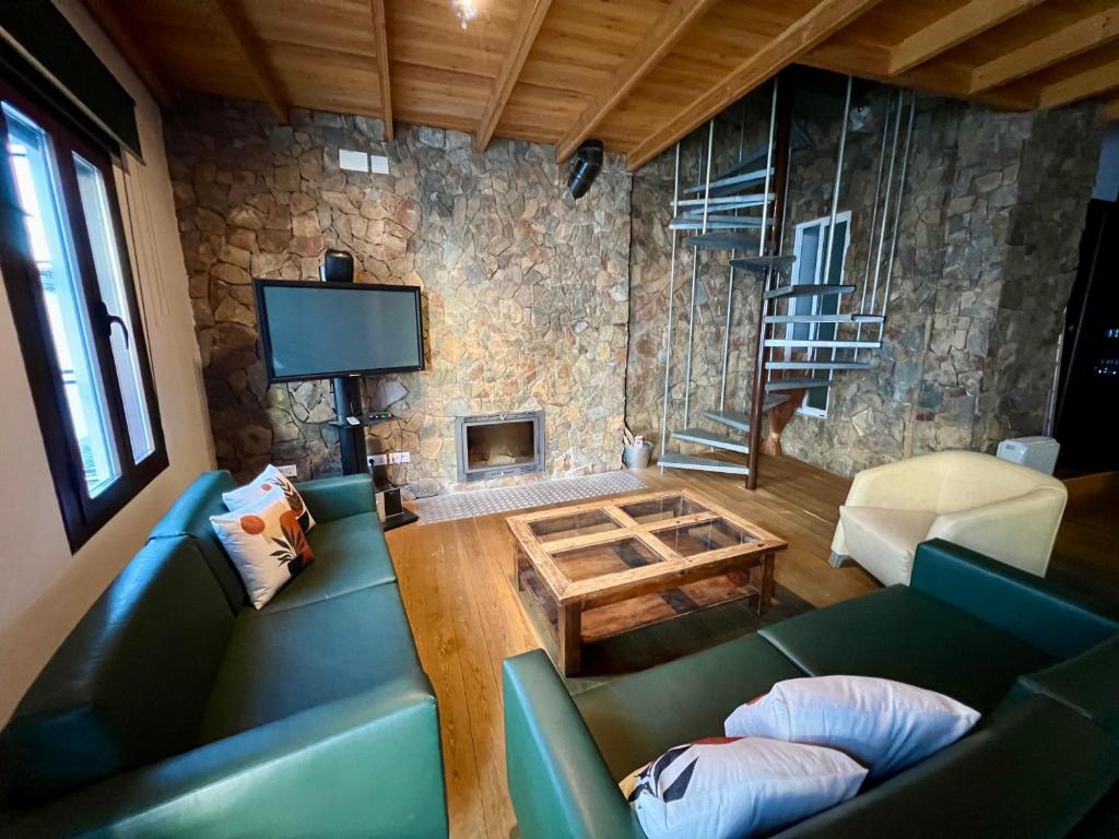 a living room with a couch and a fireplace at Casa Rural Aracena Bliss in Aracena