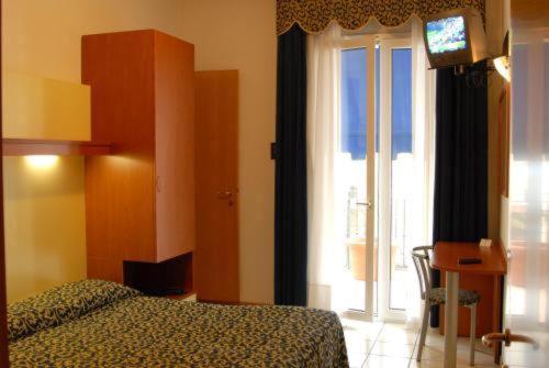 Posteľ alebo postele v izbe v ubytovaní Hotel Lido