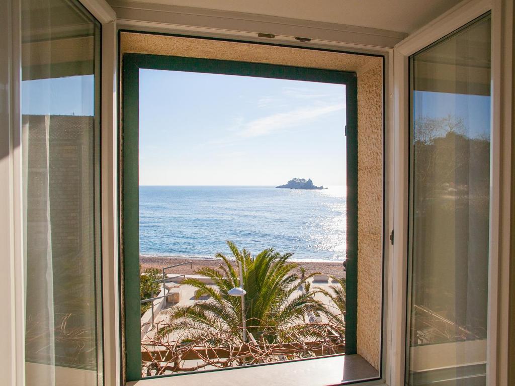 a view of the ocean from a window at Apartments Adria in Petrovac na Moru