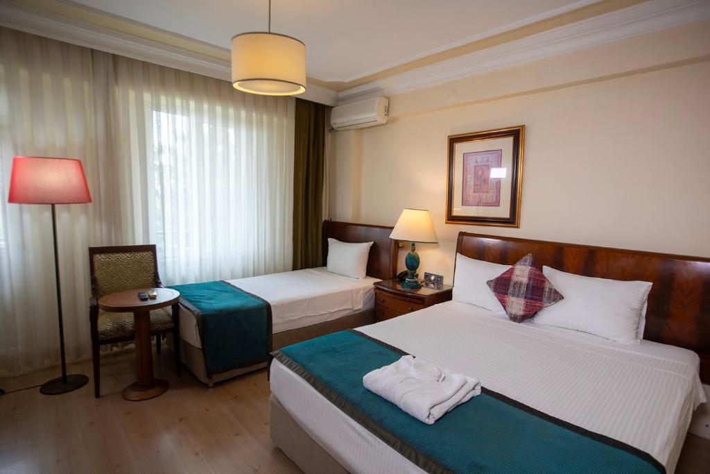Postel nebo postele na pokoji v ubytování Hotel Simsek