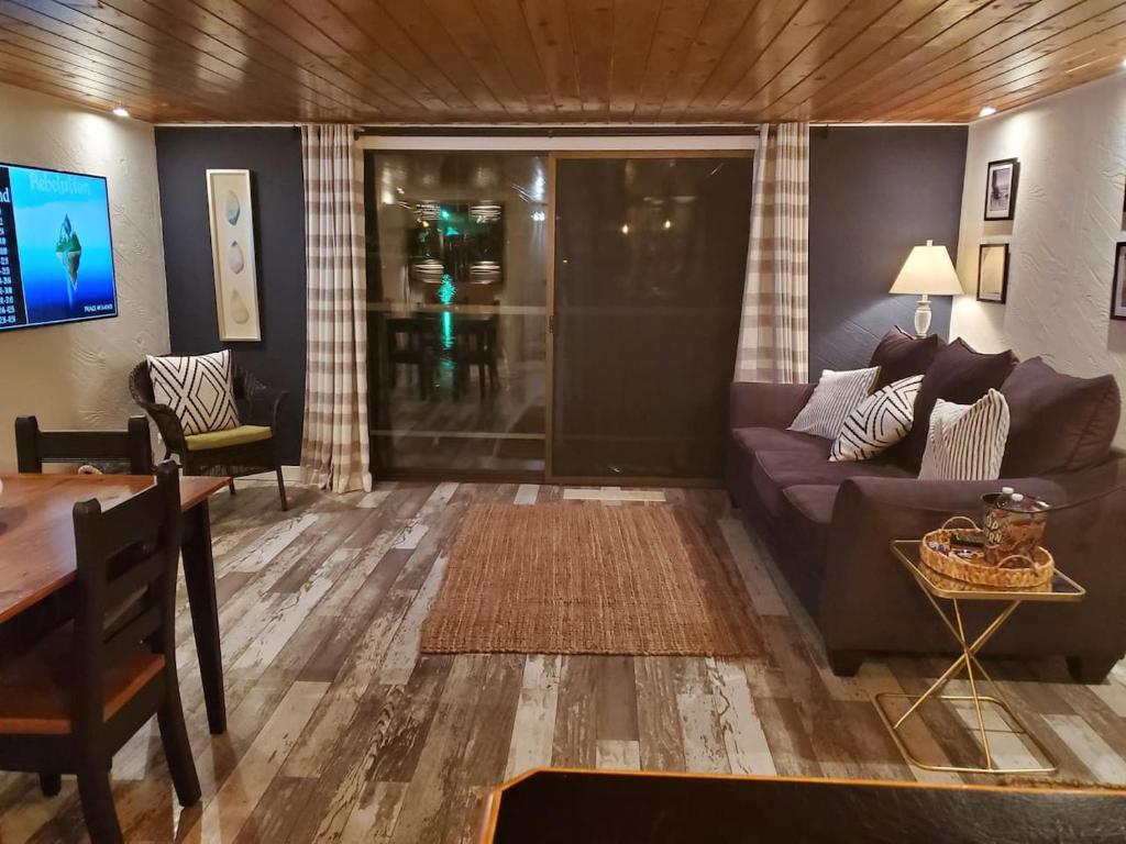 a living room with a couch and a table at Float and Relax ON the Water Float Home in Forked River