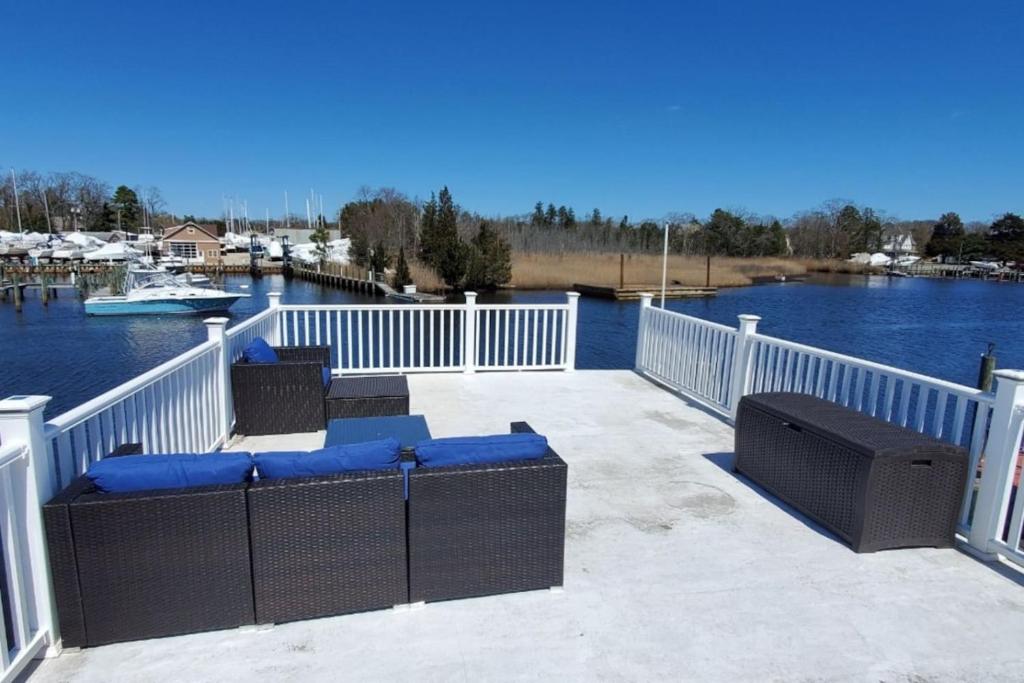 a deck with chairs and a view of the water at Float and Relax ON the Water Float Home in Forked River