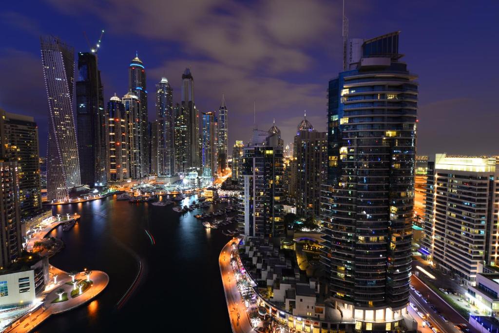 a view of a city at night with at Marina Hotel Apartments in Dubai