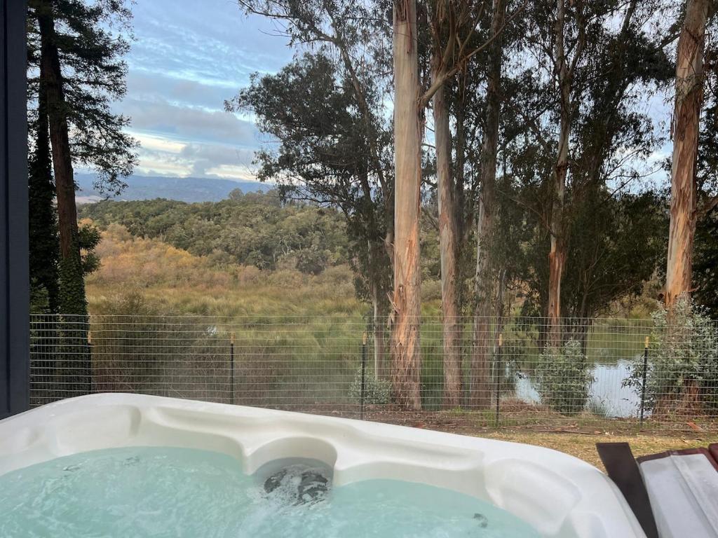 a bath tub with a view of a forest at Hidden Lake House With Hot Tub & Views! in Corralitos