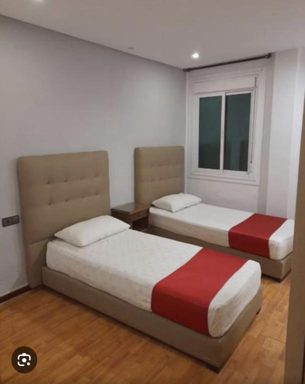Ένα ή περισσότερα κρεβάτια σε δωμάτιο στο Hotel Astoria Tanger