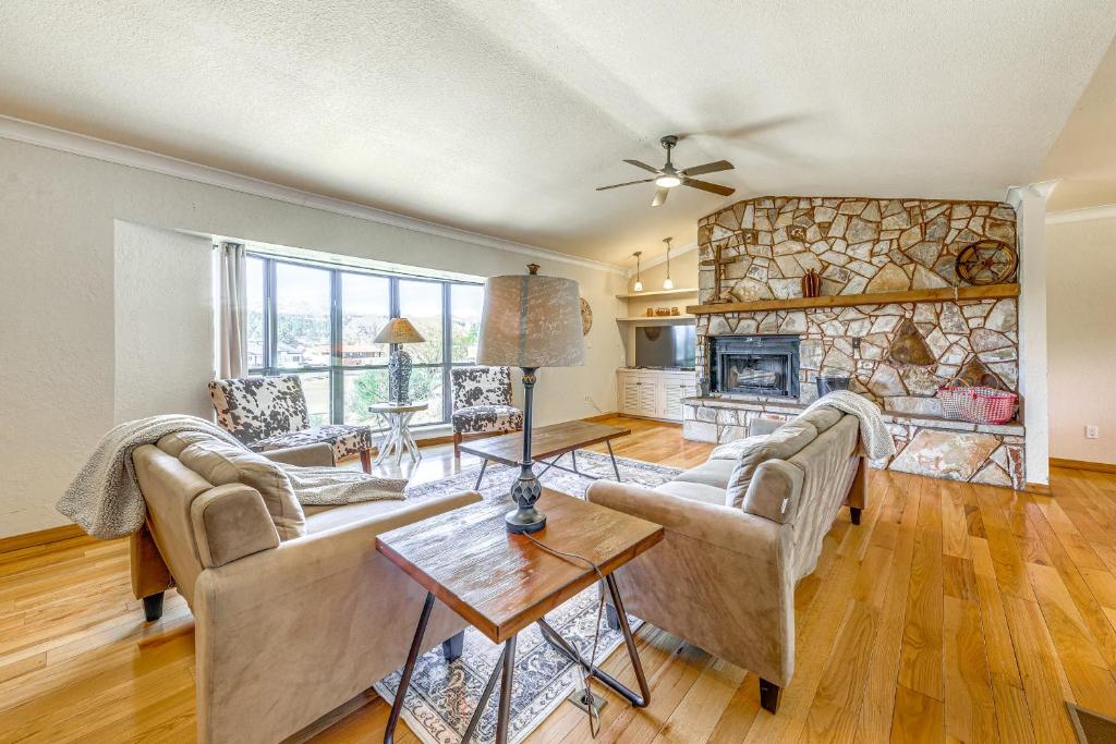 a living room with two couches and a fireplace at Spacious Ruidoso Home with Patio and Mountain Views! in Ruidoso