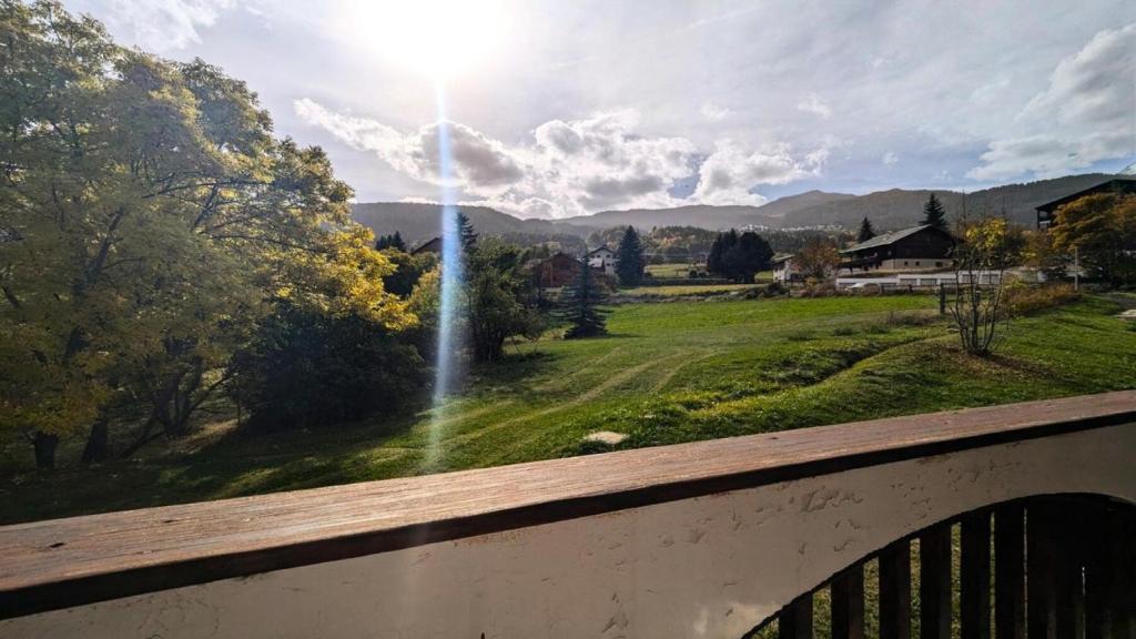una vista su un parco da un balcone illuminato dal sole di Résidence Saint Roch - Appartement T2 lumineux 4 personnes MAE-6811 a Puy-Saint-Vincent