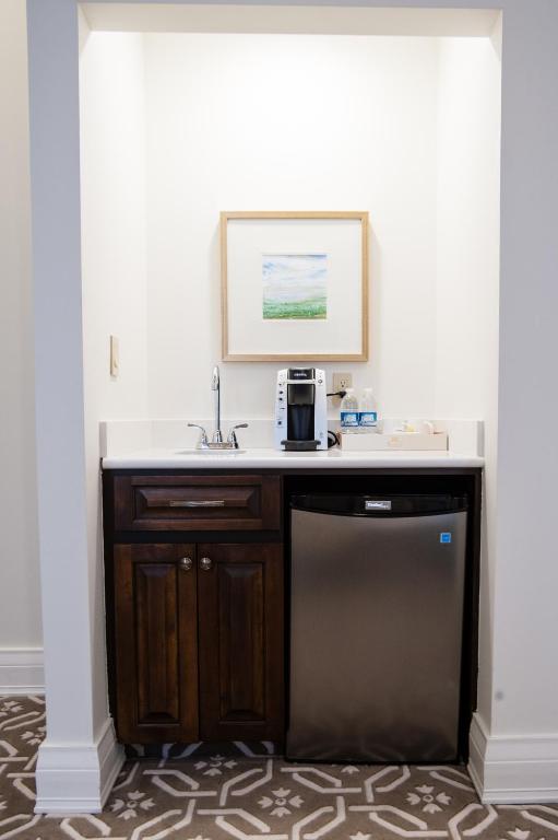 a room with a desk with a microwave on it at Sydney Boutique Inn & Suites in Charlottetown