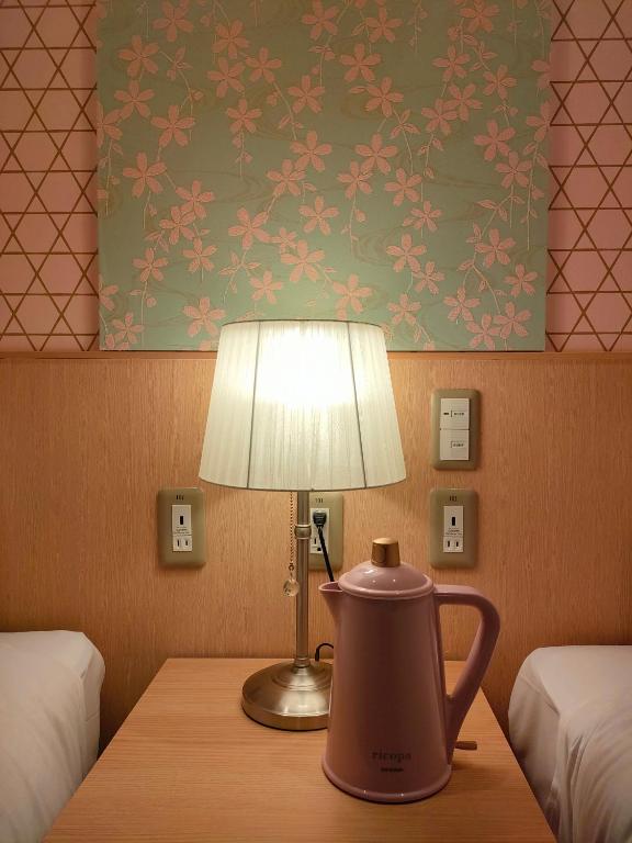 Postel nebo postele na pokoji v ubytování Hotel Sanrriott Kitahama