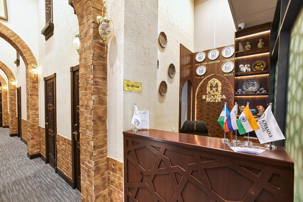 a hotel lobby with a reception desk with flags at Qo'noq Tashkent Airport Hotel Sleep Lounge & Showers, Terminal 2 - TRANSIT ONLY in Tashkent