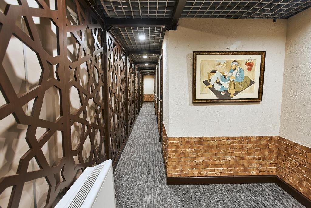a hallway with a painting on the wall at Qo'noq Tashkent Airport Hotel Sleep Lounge & Showers, Terminal 2 - TRANSIT ONLY in Tashkent