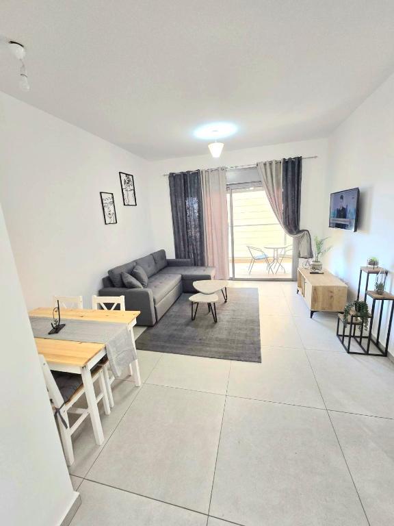 a living room with a couch and a table at EilatCasa in Eilat