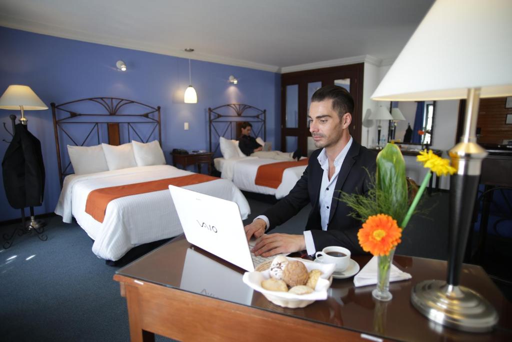 Postel nebo postele na pokoji v ubytování Hotel Ciros