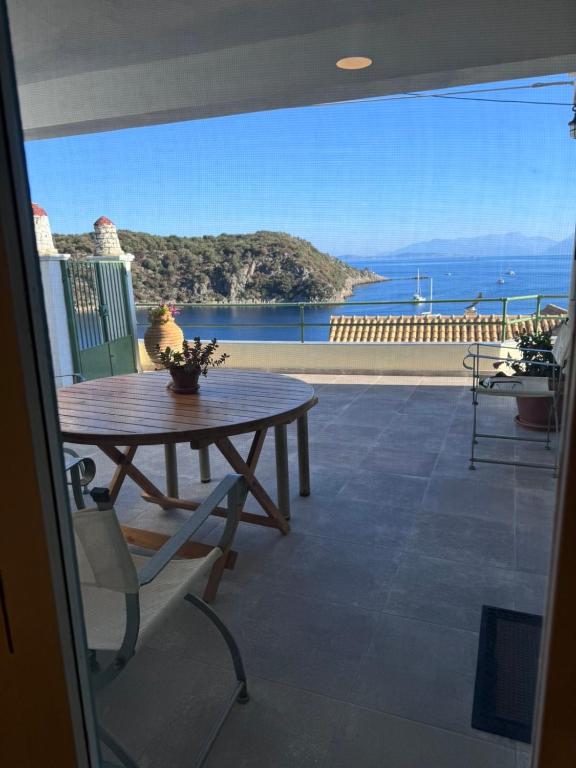 a patio with a table and a view of the ocean at Kioni - Andriana's House in Kiónion
