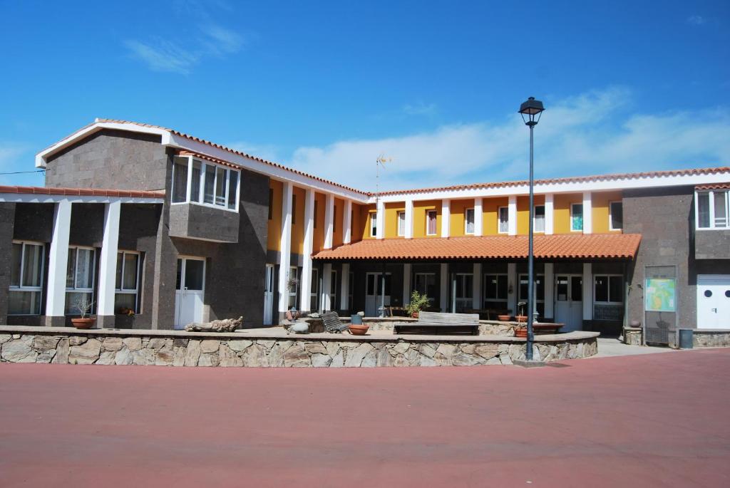 un edificio con una luz de la calle delante de él en La Hoyilla Hostel - La Aldea, en San Nicolás