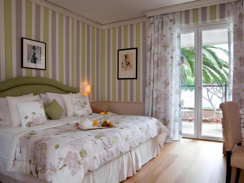 Кровать или кровати в номере Cala del Porto Punta Ala - Preferred Hotels