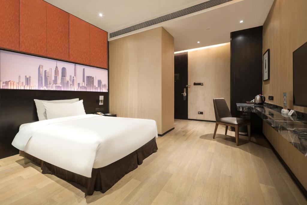 Postel nebo postele na pokoji v ubytování The Mulian Hotel Guangzhou Zhujiang New Town-Canton Fair Free Shuttle Bus