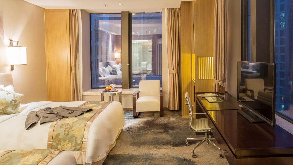 Postel nebo postele na pokoji v ubytování Yun Hotel Wuhan