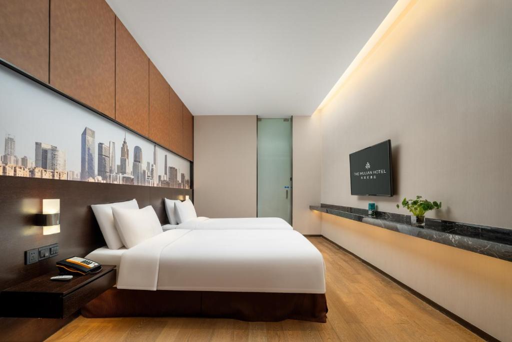 Postel nebo postele na pokoji v ubytování The Mulian Hotel Guangzhou Zhujiang New Town-Canton Fair Free Shuttle Bus