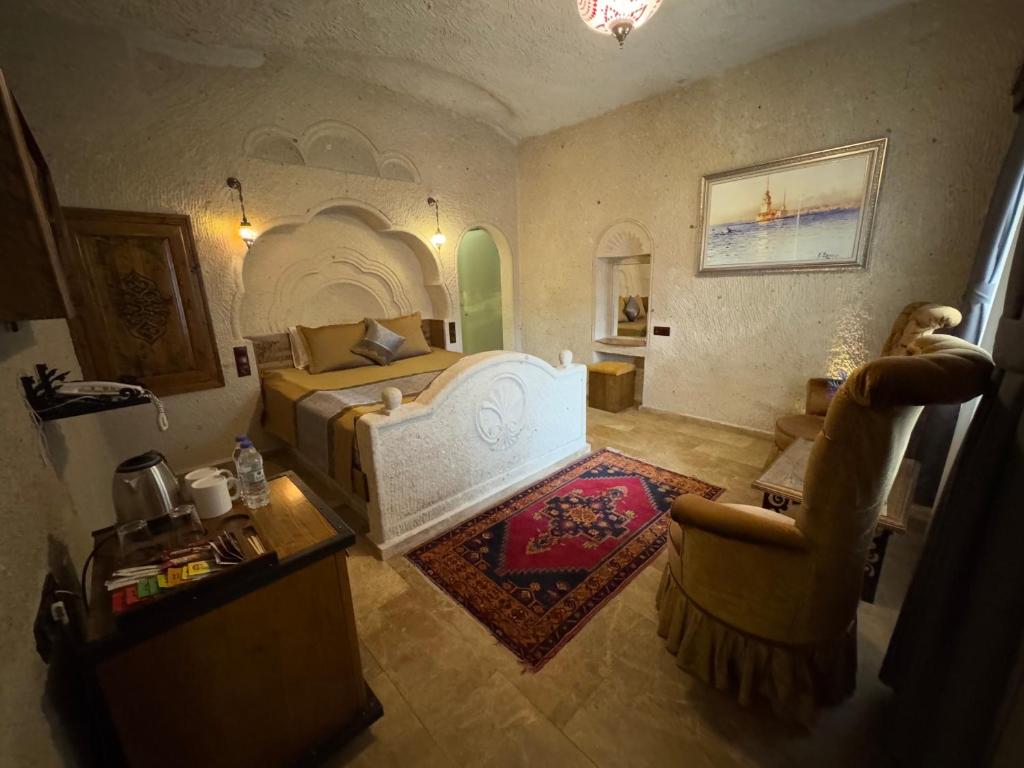 A bed or beds in a room at Cappadocia Inn Cave Hotel