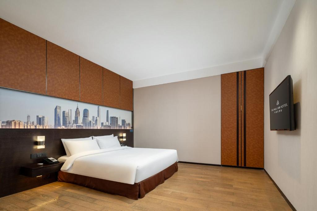 Postel nebo postele na pokoji v ubytování The Mulian Hotel Guangzhou Zhujiang New Town-Canton Fair Free Shuttle Bus