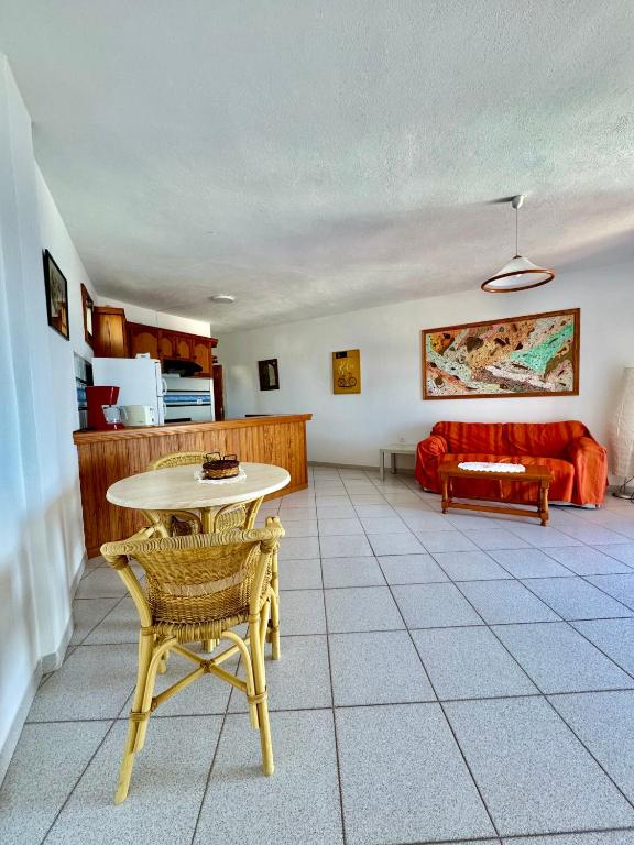 a living room with a table and a couch at Mangos Mar D in Puerto Naos