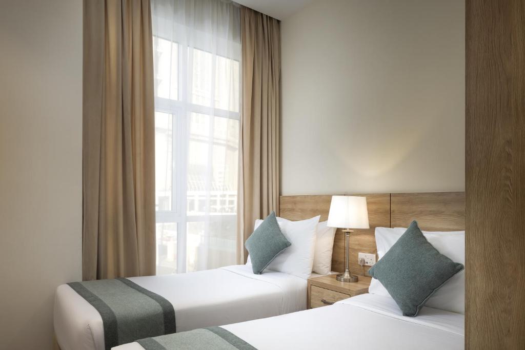 Postel nebo postele na pokoji v ubytování Worth Elite Hotel