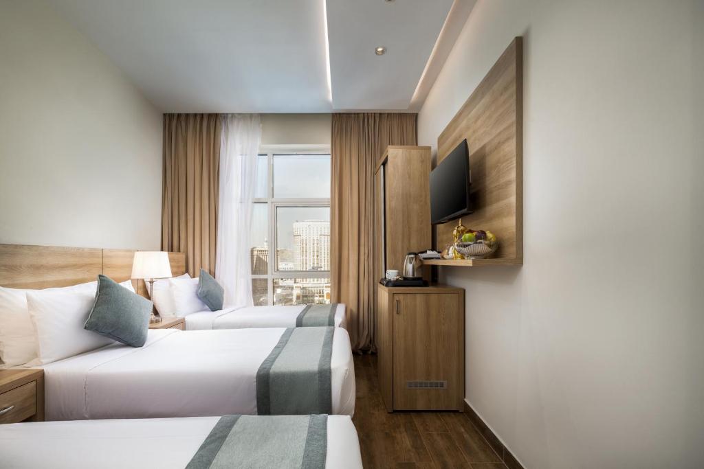 Postel nebo postele na pokoji v ubytování Worth Elite Hotel