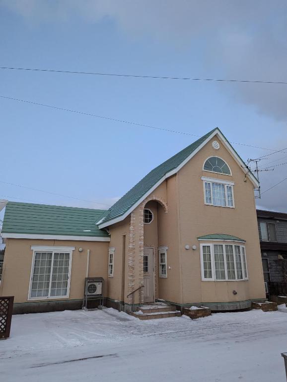 a large brown house with a green roof at 1棟貸し Villa YOU hokkaido date toya in Date