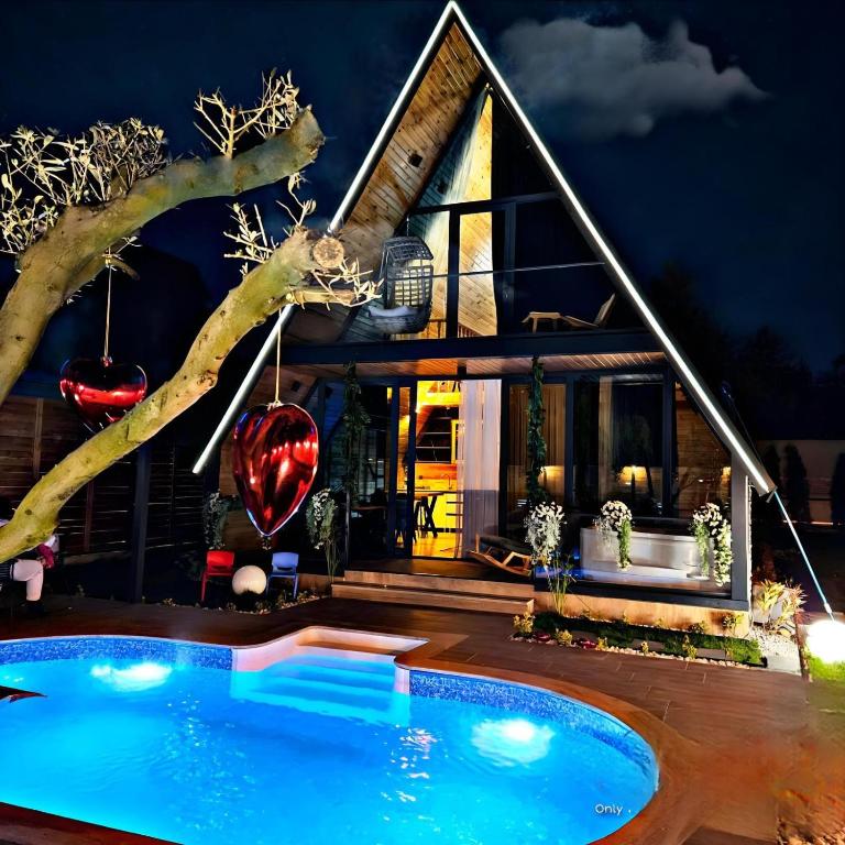 a house with a swimming pool in front of it at 7Sense Nature Resort in Sapanca