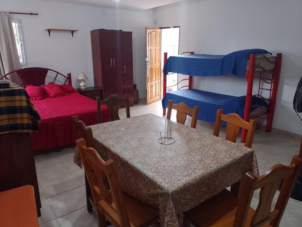 a dining room with a table and a bunk bed at Aires de San Antonio in San Antonio de Arredondo
